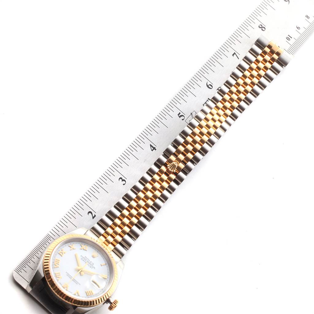 The image shows a Rolex Datejust 116233 Men's Stainless Steel Mother of Pearl Dial 116233 Men's Stainless Steel Mother of Pearl Dial watch laid flat next to a ruler, highlighting its face, bezel, crown, and bracelet.