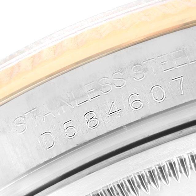 This is a close-up view of the serial number and "STAINLESS STEEL" engraving on the side of the bezel of a Rolex Datejust 116233 Men's Stainless Steel Mother of Pearl Dial 116233 Men's Stainless Steel Mother of Pearl Dial watch.