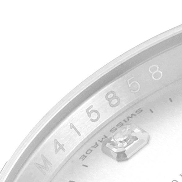 This image shows a close-up of the underside of the bezel and part of the dial of a Rolex Datejust 116234 Men's Stainless Steel Silver Dial 116234 Men's Stainless Steel Silver Dial watch.