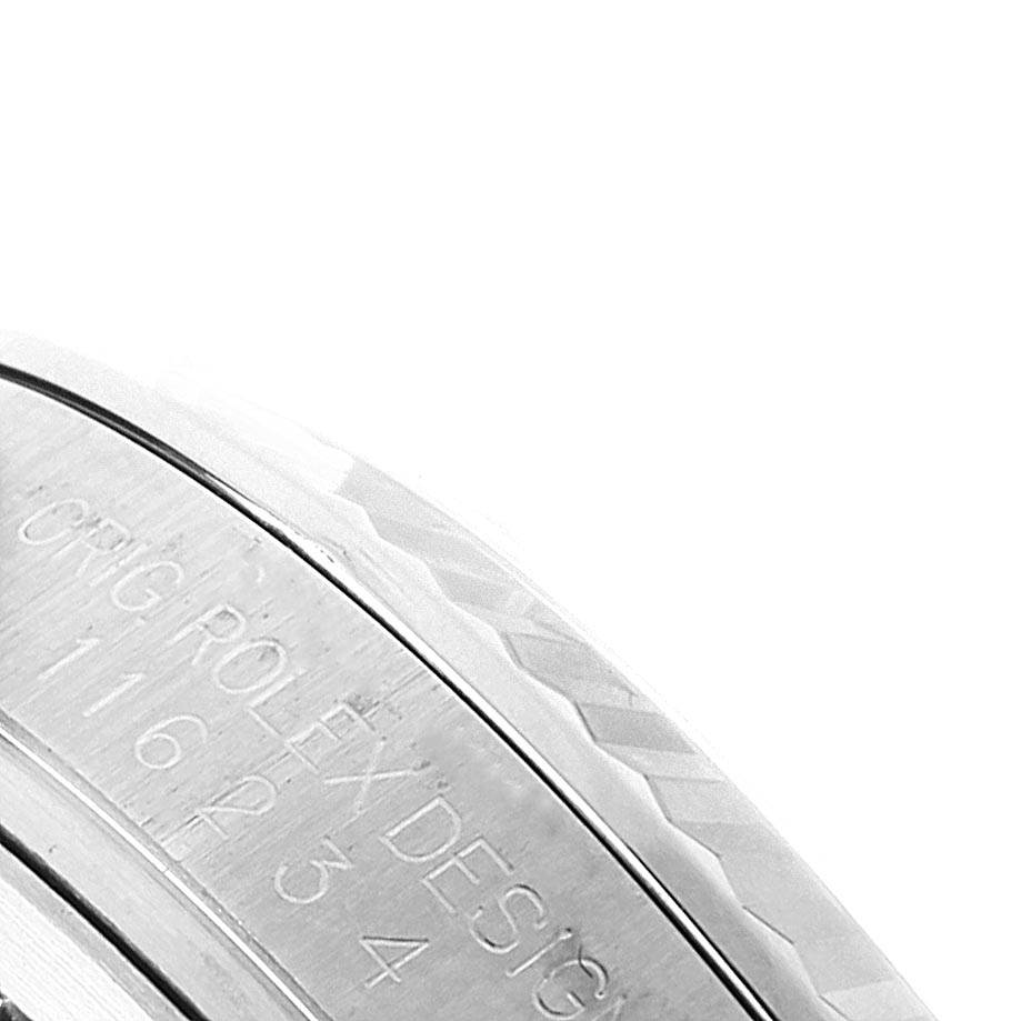 This close-up image shows the engraved side of the case of a Rolex Datejust 116234 Men's Stainless Steel Silver Dial 116234 Men's Stainless Steel Silver Dial watch.