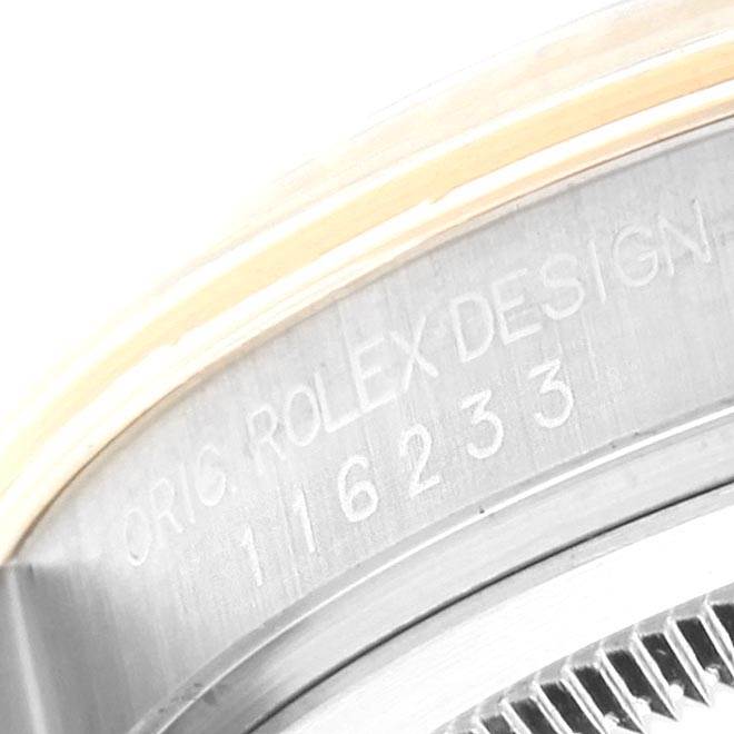 The image displays the engraved model and design information on the case side of a Rolex Datejust 116233 Men
s Steel and Gold (two tone) Blue Dial 116233 Men
s Steel and Gold (two tone) Blue Dial watch.