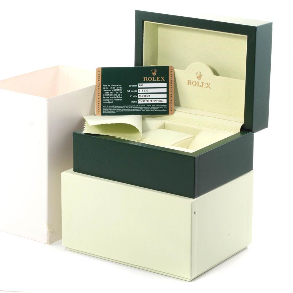 The image shows a Rolex Datejust 116233 Men
s Steel and Gold (two tone) Blue Dial 116233 Men
s Steel and Gold (two tone) Blue Dial watch box, with an open lid displaying paperwork and a cleaning cloth.