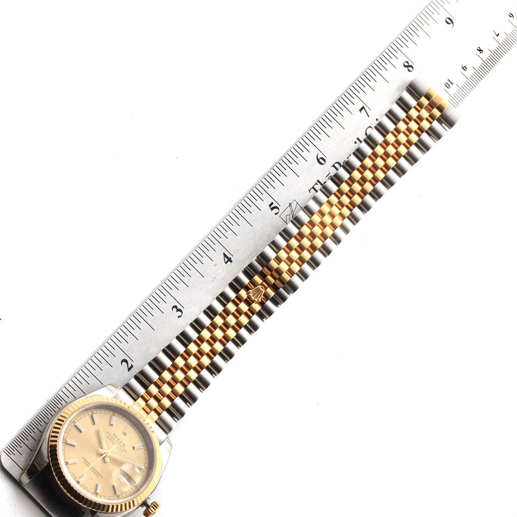 The image shows a Rolex Datejust 116233 Men's Stainless Steel Champagne Dial 116233 Men's Stainless Steel Champagne Dial watch laid flat, with a ruler measuring its two-tone bracelet.