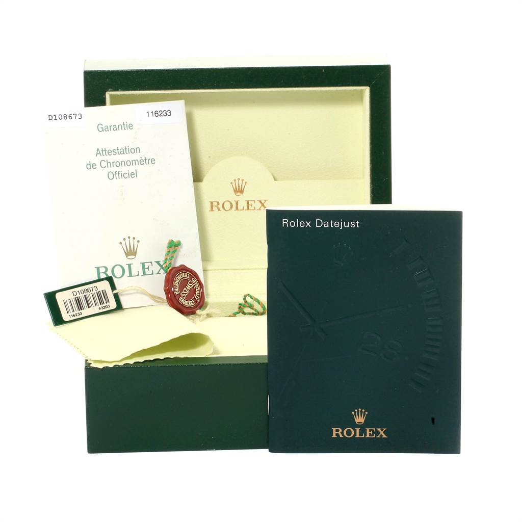 The image shows the accessories of a Rolex Datejust 116233 Men's Stainless Steel Blue Dial 116233 Men's Stainless Steel Blue Dial, including the warranty card, booklet, hang tag, and box.