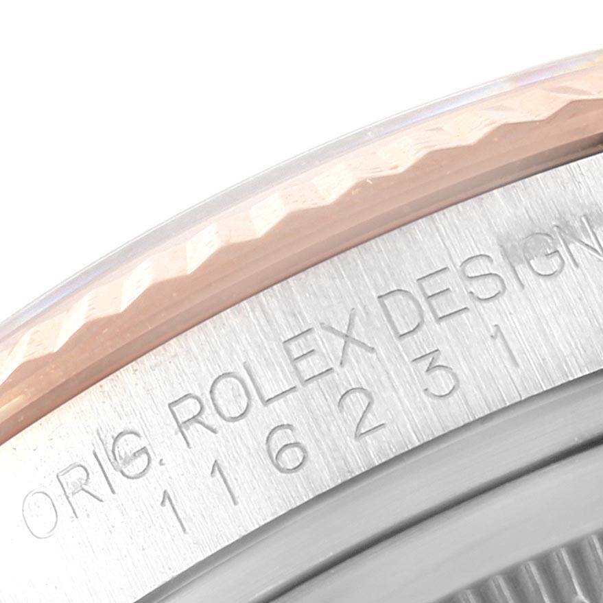 The image shows a partial view of the bezel and serial number engraving on a Rolex Datejust 116231 Men's Steel and Gold (two tone) Pink Dial 116231 Men's Steel and Gold (two tone) Pink Dial watch.
