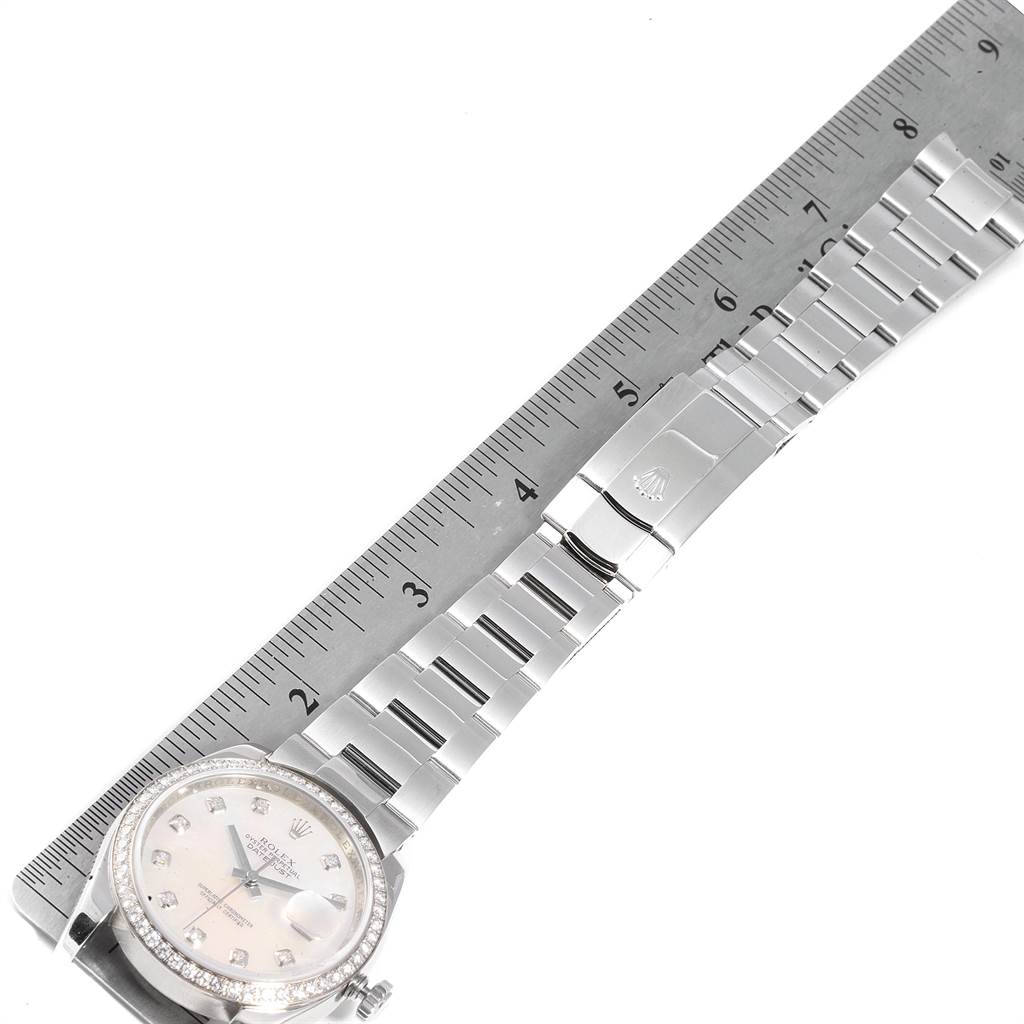 The image shows a side view of the Rolex Datejust 116244 Men's Stainless Steel Mother of Pearl Dial 116244 Men's Stainless Steel Mother of Pearl Dial watch, including the bracelet and clasp next to a ruler.