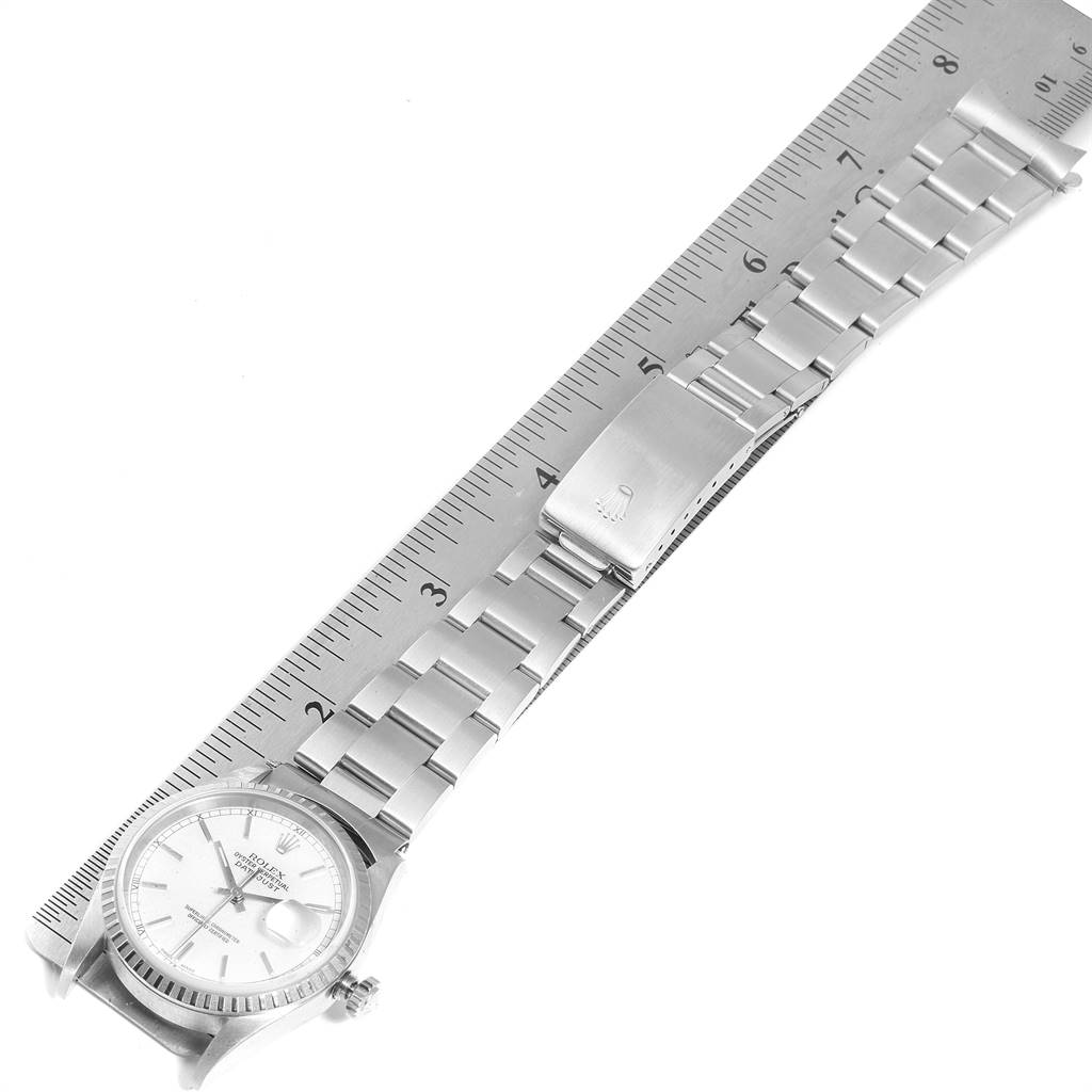 The image shows a Rolex Datejust 16220 Men's Stainless Steel White Dial 16220 Men's Stainless Steel White Dial watch laid flat alongside a ruler, capturing the bracelet, clasp, and part of the dial.