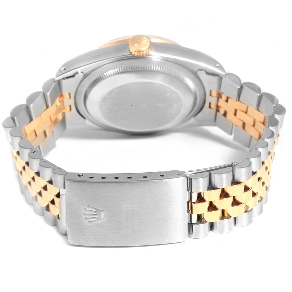 This image shows the back case, crown, and two-tone bracelet of a Rolex Datejust 16233 Men's Steel and Gold (two tone) Champagne Dial 16233 Men's Steel and Gold (two tone) Champagne Dial watch.