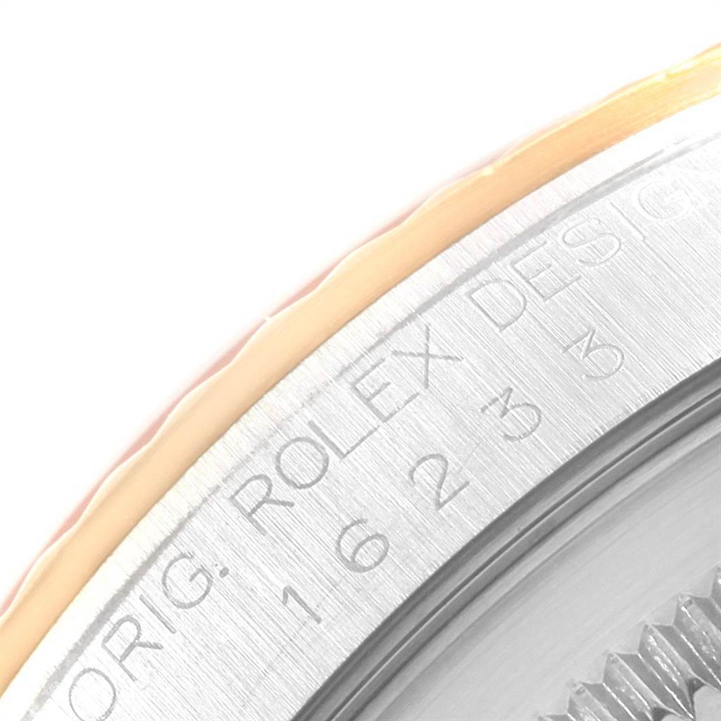 The image shows a close-up angle of the bezel and edge of the case back of a Rolex Datejust 16233 Men's Steel and Gold (two tone) Champagne Dial 16233 Men's Steel and Gold (two tone) Champagne Dial watch, highlighting its engraved details.