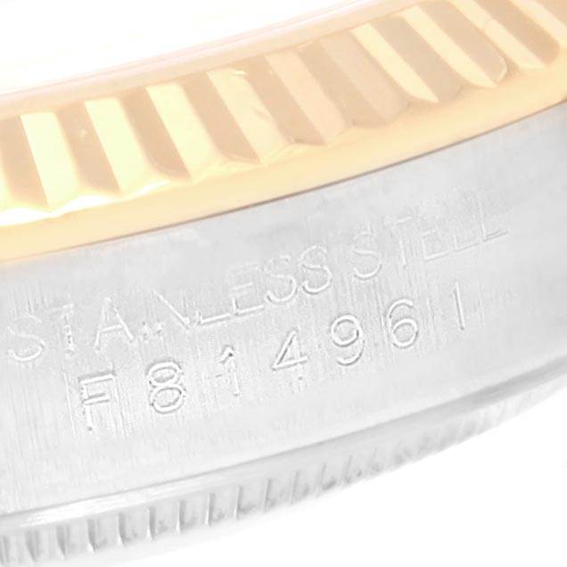 This image shows a close-up of the case side and serrated bezel of a Rolex Datejust 116233 Men's Stainless Steel Beige Dial 116233 Men's Stainless Steel Beige Dial watch, highlighting the engraved serial number.