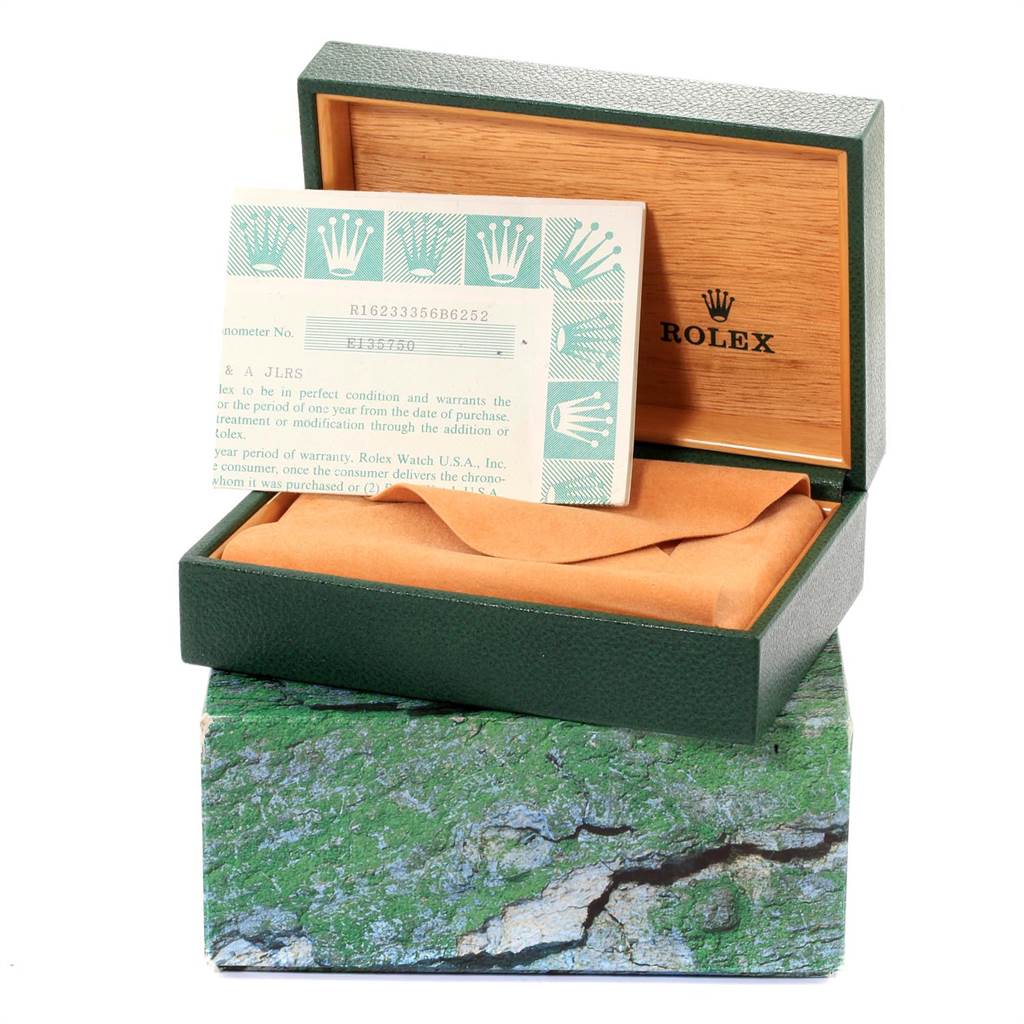 The image shows a Rolex Datejust 16233 Men
s Steel and Gold (two tone) Black Dial 16233 Men
s Steel and Gold (two tone) Black Dial watch
s open box with warranty papers inside and packaging displayed.