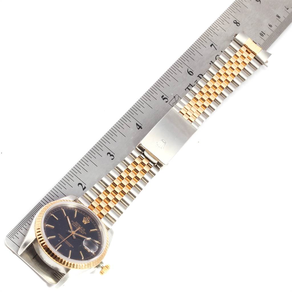 The Rolex Datejust 16233 Men
s Steel and Gold (two tone) Black Dial 16233 Men
s Steel and Gold (two tone) Black Dial watch is displayed flat, with the band measured by a ruler from the face to the clasp.