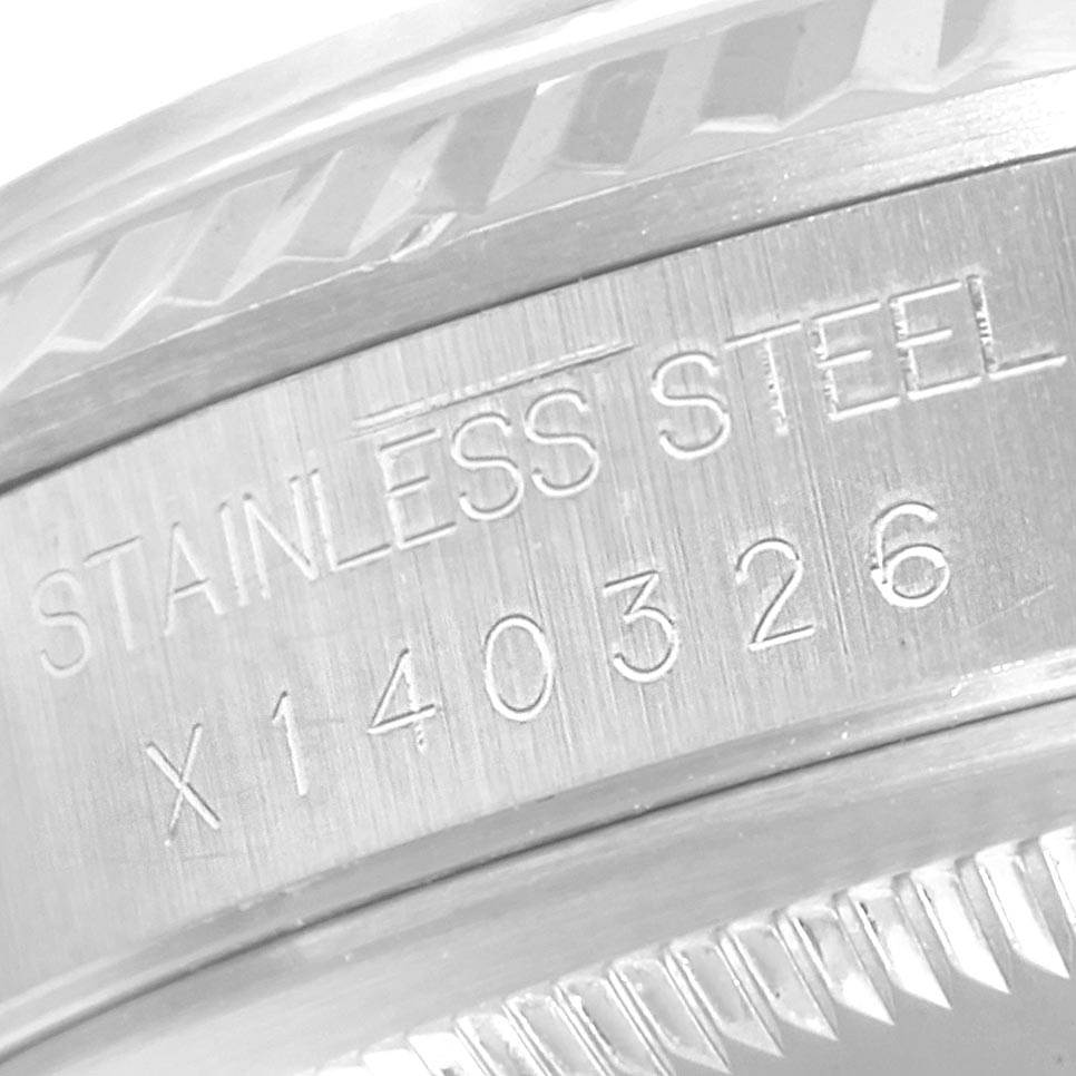 The image shows a close-up view of the stainless steel bezel with engravings on a Rolex Datejust 16234 Men's Stainless Steel Blue Dial 16234 Men's Stainless Steel Blue Dial watch.