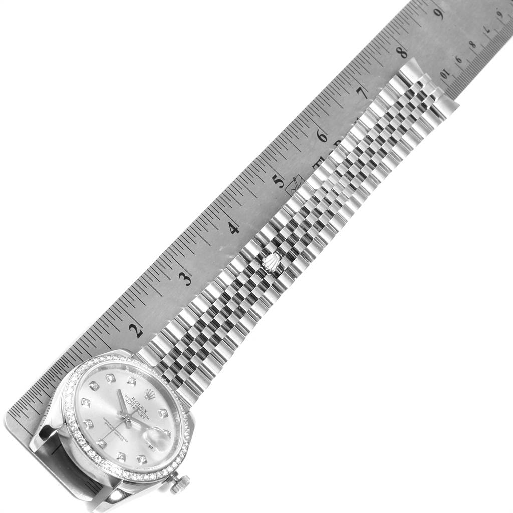 The image shows the Rolex Datejust 116244 Men's Stainless Steel Silver Dial 116244 Men's Stainless Steel Silver Dial watch with its face and bracelet laid out next to a ruler for measurement.