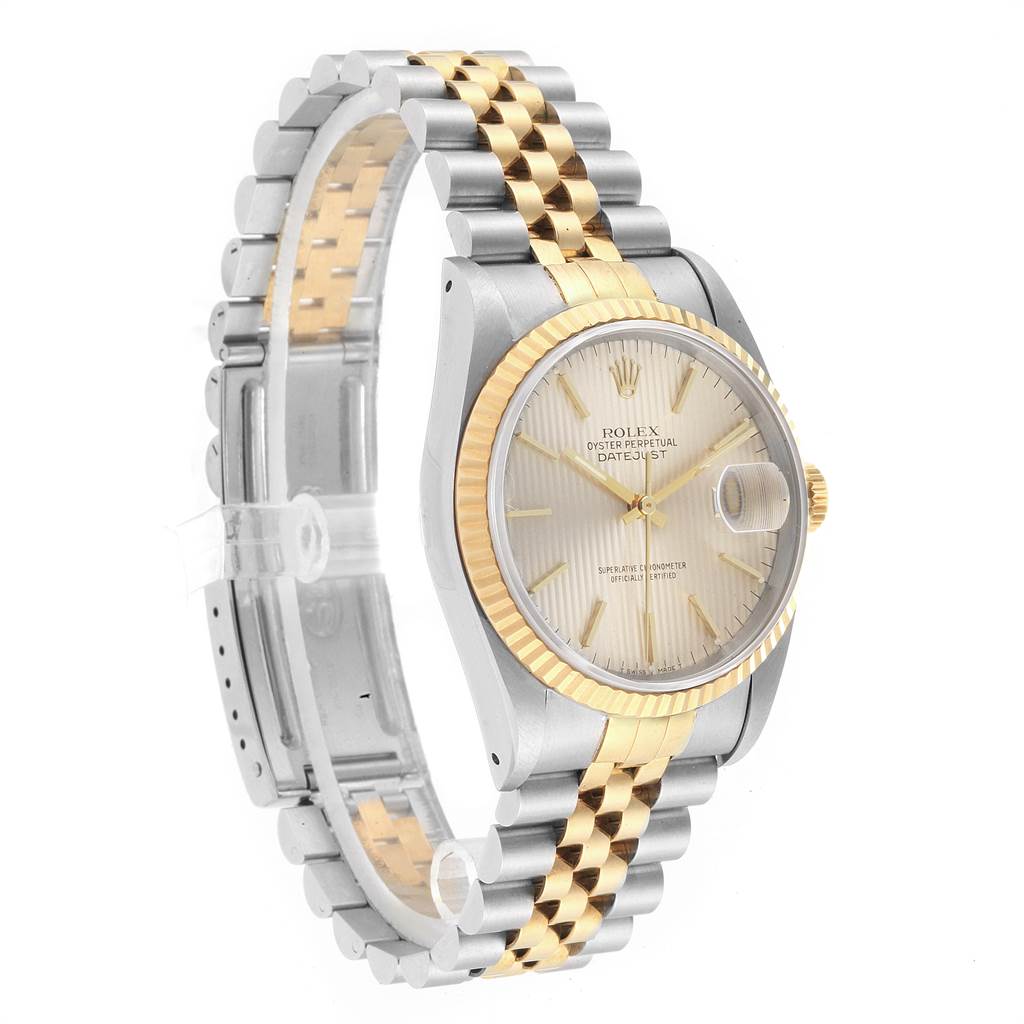This Rolex Datejust 16233 Men's Steel and Gold (two tone) Silver Dial 16233 Men's Steel and Gold (two tone) Silver Dial model watch is shown at a side angle, displaying its dial, bezel, and two-tone bracelet.