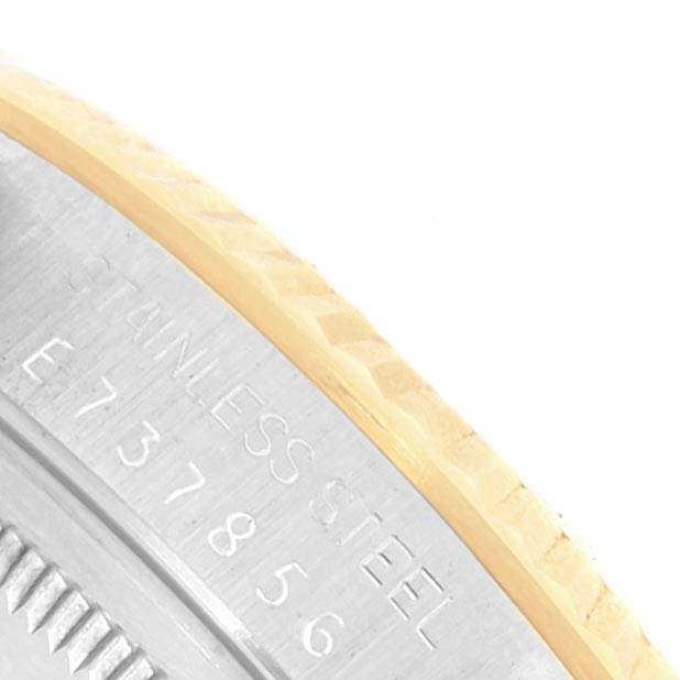 This close-up image shows the edge of the bezel and case back of a Rolex Datejust 16233 Men's Steel and Gold (two tone) Silver Dial 16233 Men's Steel and Gold (two tone) Silver Dial watch, highlighting the engraved serial number and "STAINLESS STEEL" text.