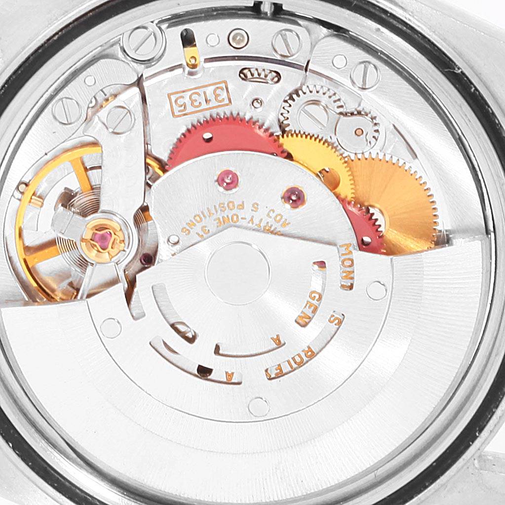 The image shows the intricate internal mechanism of the Rolex Datejust 16233 Men's Steel and Gold (two tone) Silver Dial 16233 Men's Steel and Gold (two tone) Silver Dial watch from an open-case back angle.