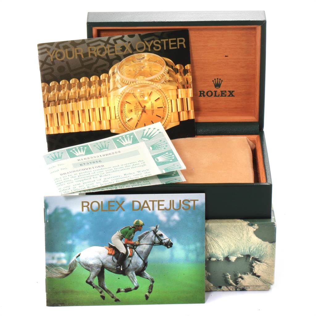 The image shows a Rolex Datejust 16233 Men's Steel and Gold (two tone) Silver Dial 16233 Men's Steel and Gold (two tone) Silver Dial box and its accessories, including manuals and warranty papers, viewed from the front.