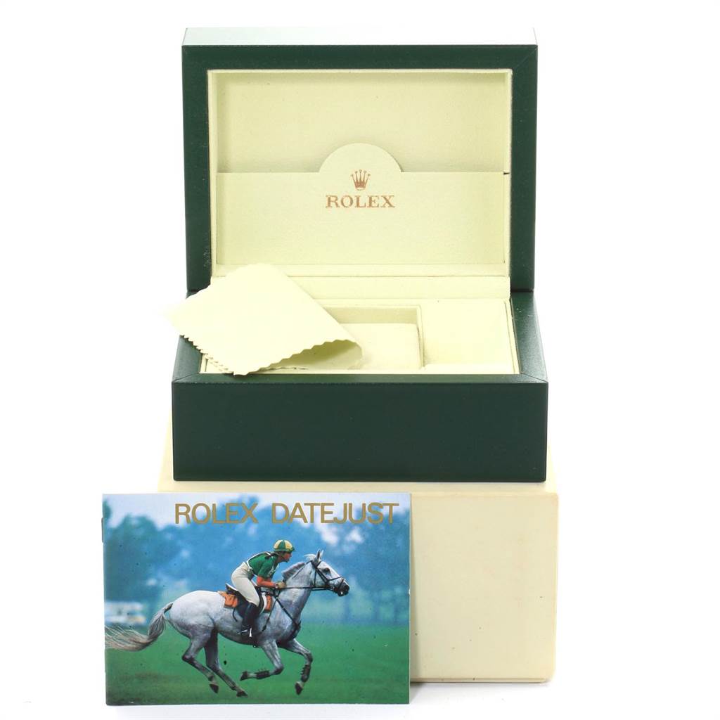 This image shows a Rolex Datejust 16200 Men's Stainless Steel Blue Dial 16200 Men's Stainless Steel Blue Dial watch box, cleaning cloth, and booklet from a front angle.