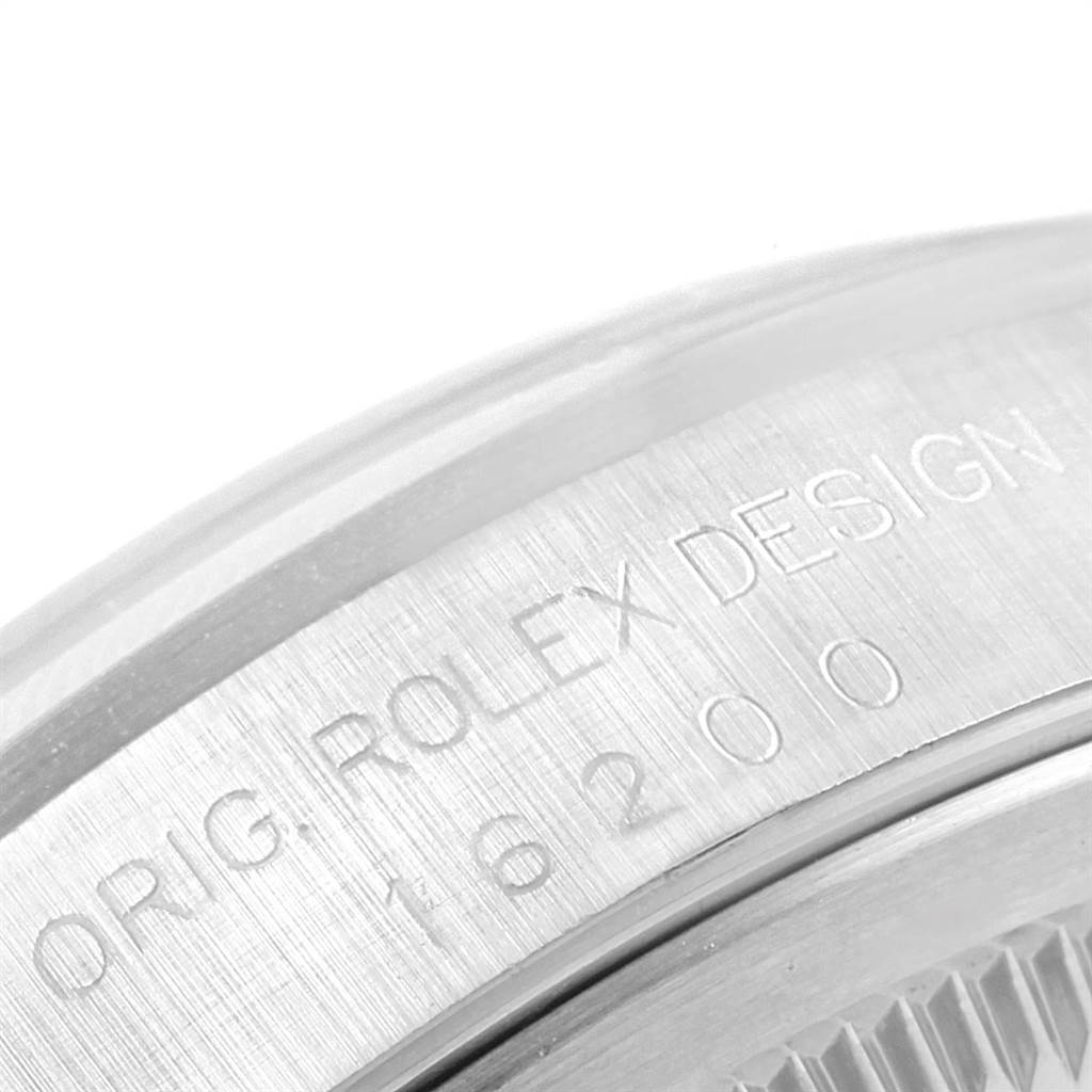 The image shows an angled close-up of the engraved case back of a Rolex Datejust 16200 Men's Stainless Steel Blue Dial 16200 Men's Stainless Steel Blue Dial model.