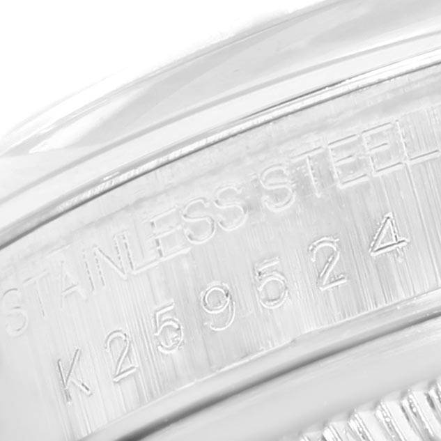 This is a close-up angled view of the stainless steel case side engraving on the Rolex Datejust 16200 Men's Stainless Steel Blue Dial 16200 Men's Stainless Steel Blue Dial watch, showing part of its serial number.