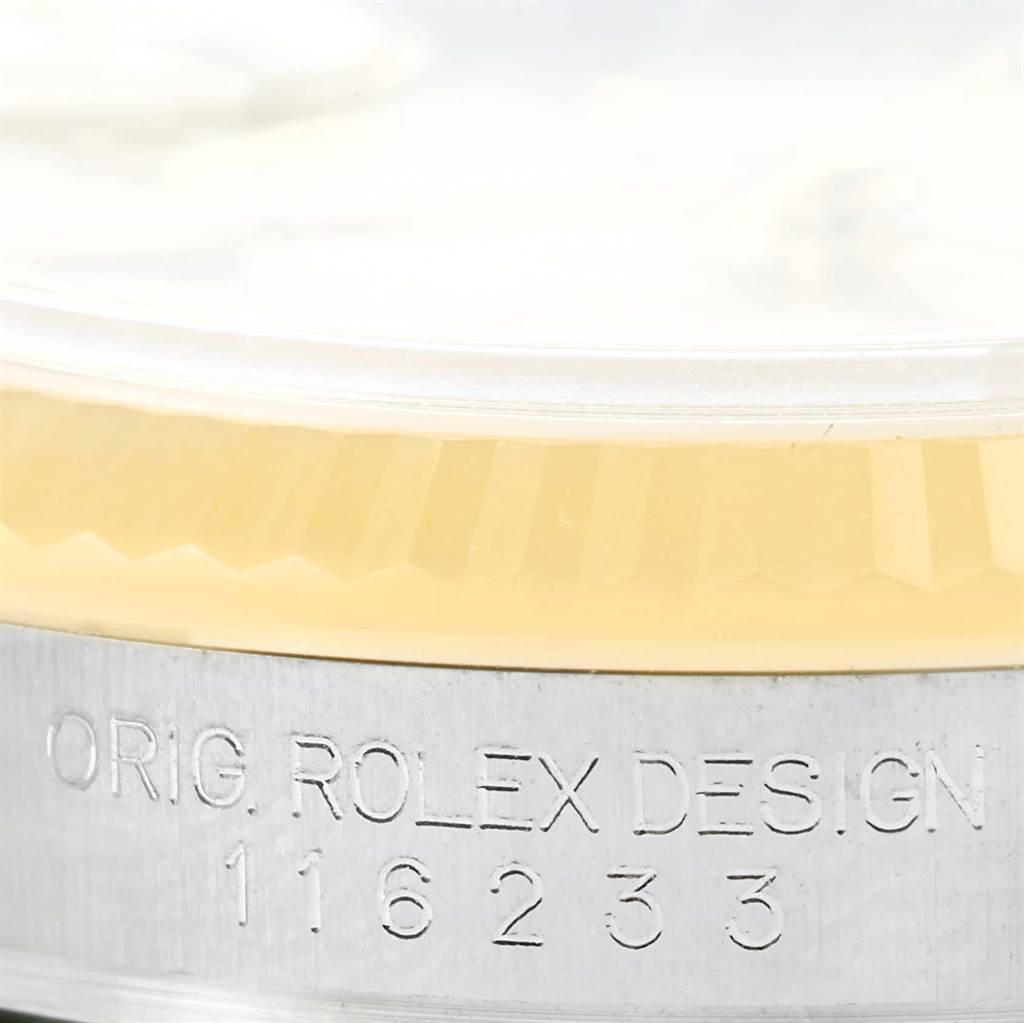 This image shows a close-up of the side of the case and part of the bezel of a Rolex Datejust 116233 Men's Stainless Steel Champagne Dial 116233 Men's Stainless Steel Champagne Dial watch, featuring the engraved model number "116233."