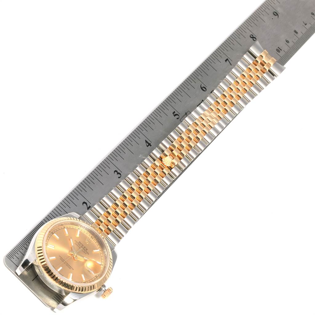 The image shows a Rolex Datejust 116233 Men's Stainless Steel Champagne Dial 116233 Men's Stainless Steel Champagne Dial watch laid flat with its bracelet extended along a ruler for measurement.