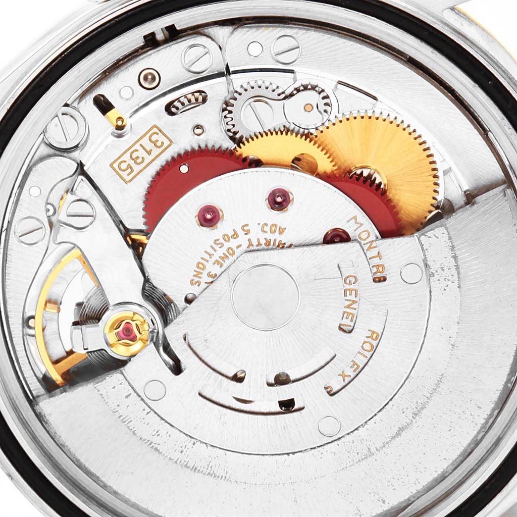 The image shows the inner mechanical components of a Rolex Datejust 16233 Men's Steel and Gold (two tone) Black Dial 16233 Men's Steel and Gold (two tone) Black Dial watch, including gears and the rotor.