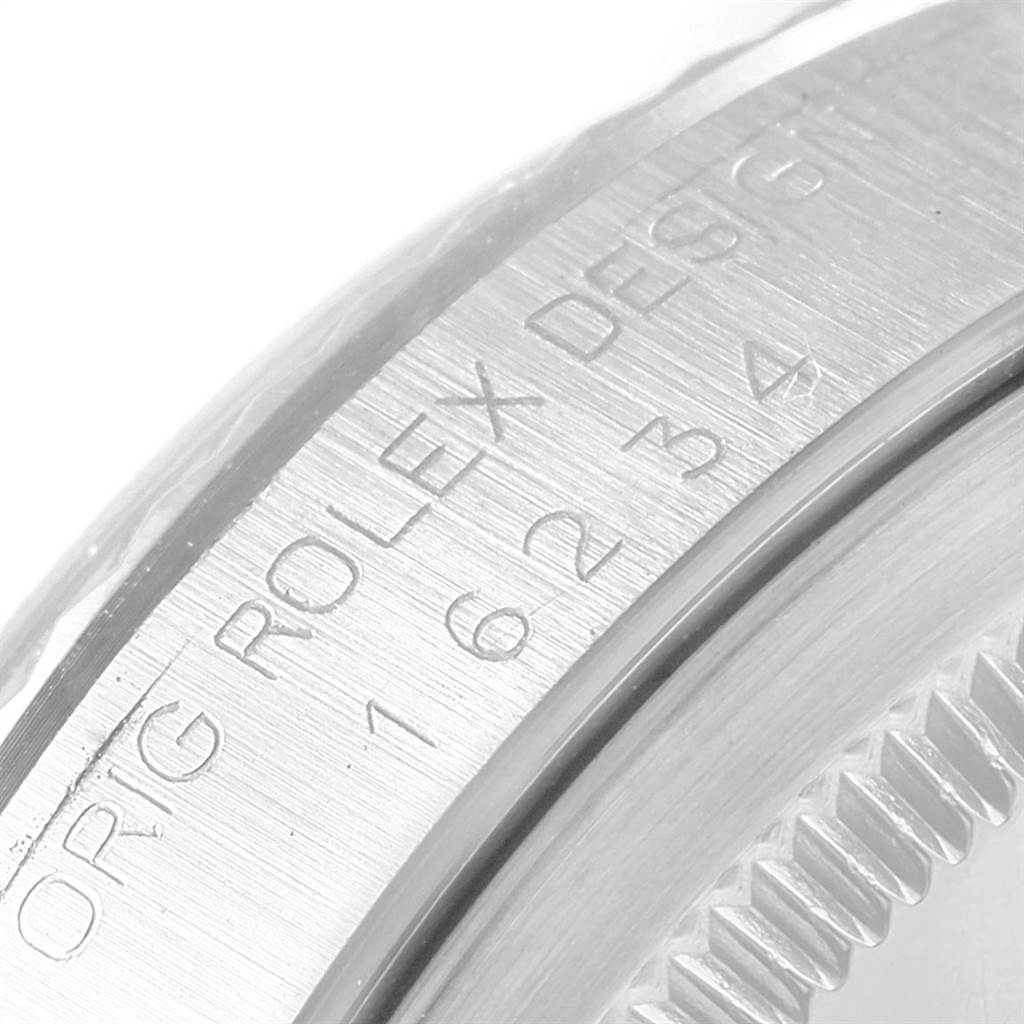 The image shows a close-up of the engravings on the case side and bezel of a Rolex Datejust 16234 Men's Stainless Steel White Dial 16234 Men's Stainless Steel White Dial.