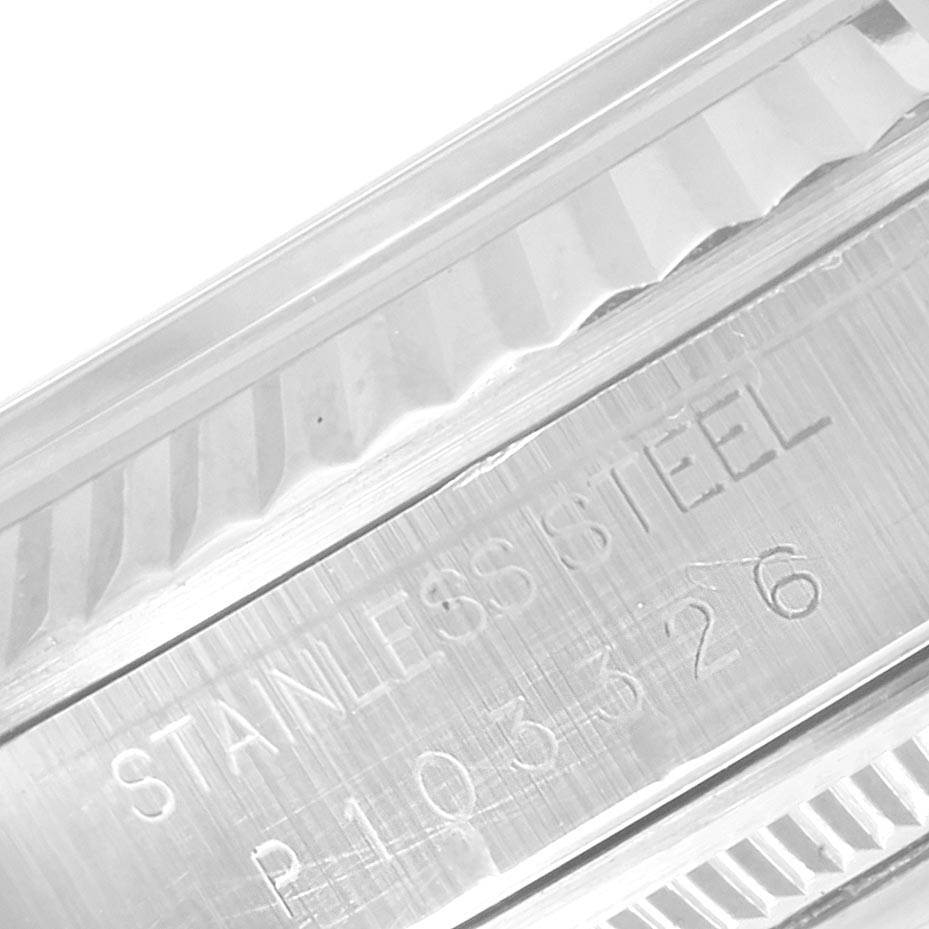 The image shows a close-up angle of the fluted bezel and serial engraving on a Rolex Datejust 16234 Men's Stainless Steel White Dial 16234 Men's Stainless Steel White Dial watch in stainless steel.