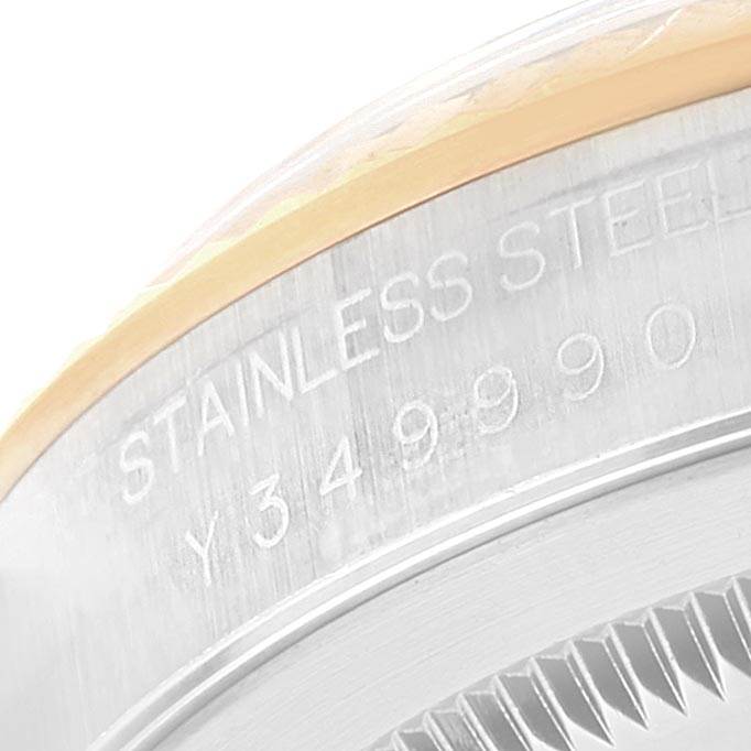 This image shows a close-up of the caseback engraving on a Rolex Datejust 16233 Men's Steel and Gold (two tone) White Dial 16233 Men's Steel and Gold (two tone) White Dial watch, displaying the serial number and "STAINLESS STEEL" text.