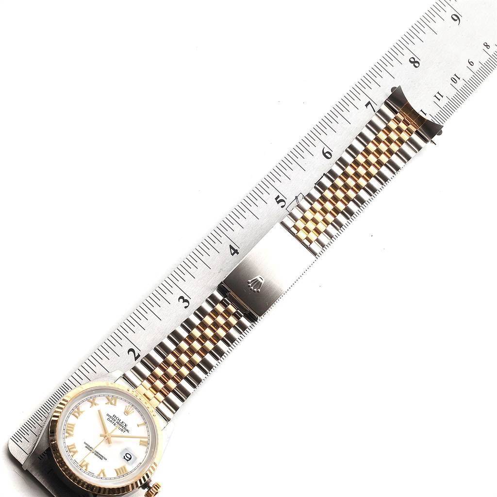 This image shows a Rolex Datejust 16233 Men's Steel and Gold (two tone) White Dial 16233 Men's Steel and Gold (two tone) White Dial watch laid out flat, featuring the face, bezel, and bracelet with a ruler for measurement.