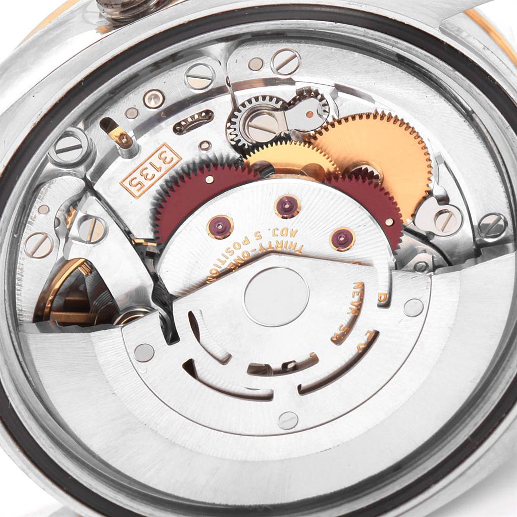 This image shows a close-up view of the mechanical movement inside a Rolex Datejust 116243 Men's Stainless Steel Silver Dial 116243 Men's Stainless Steel Silver Dial watch, highlighting gears and components.