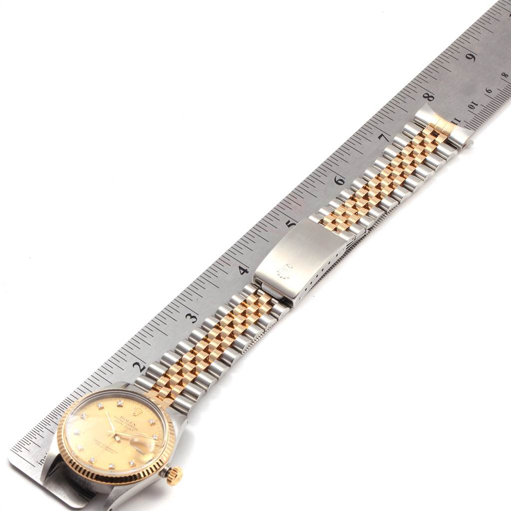 The image shows a Rolex Datejust 16013 Men's Stainless Steel Champagne Dial 16013 Men's Stainless Steel Champagne Dial watch laid flat against a ruler, displaying its face, bracelet, and clasp.