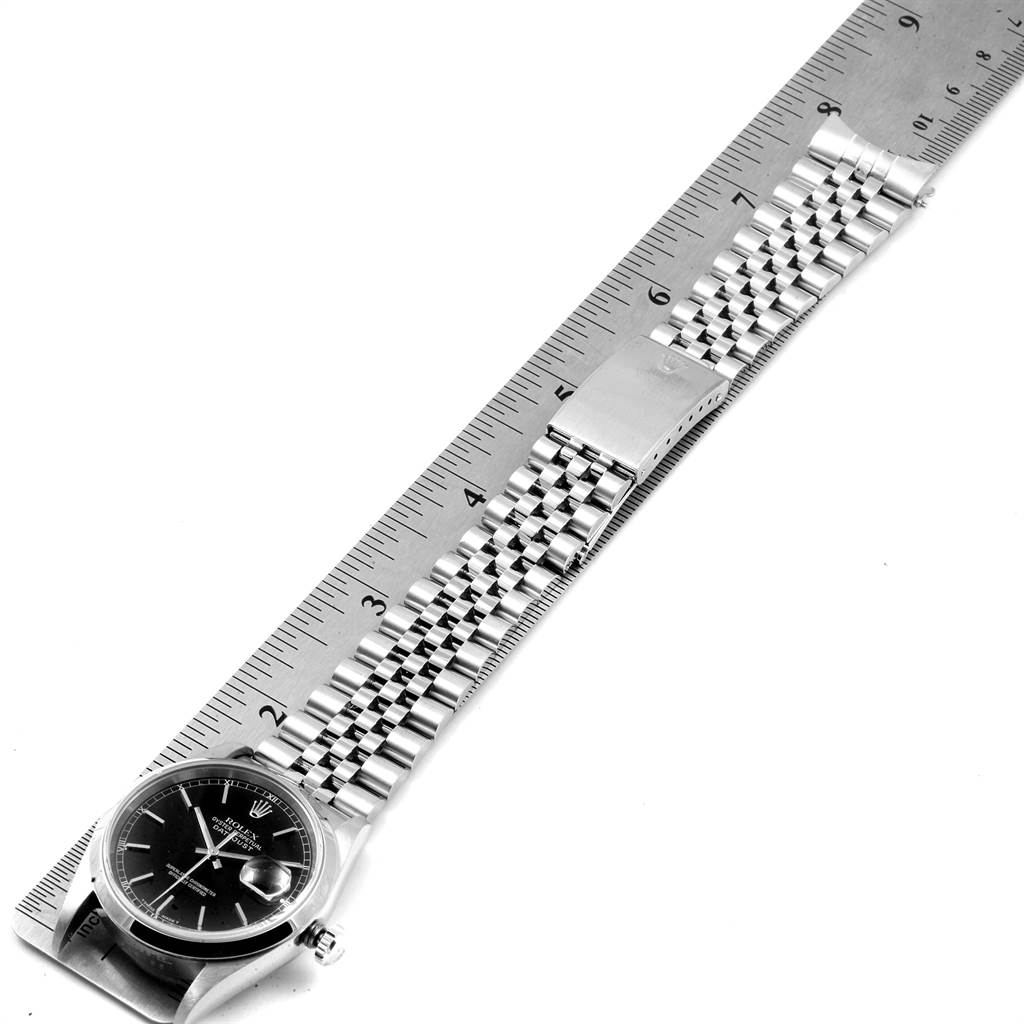 The image shows a Rolex Datejust 16200 Men's Stainless Steel Black Dial 16200 Men's Stainless Steel Black Dial watch with its face and bracelet laid flat against a ruler for measurement.