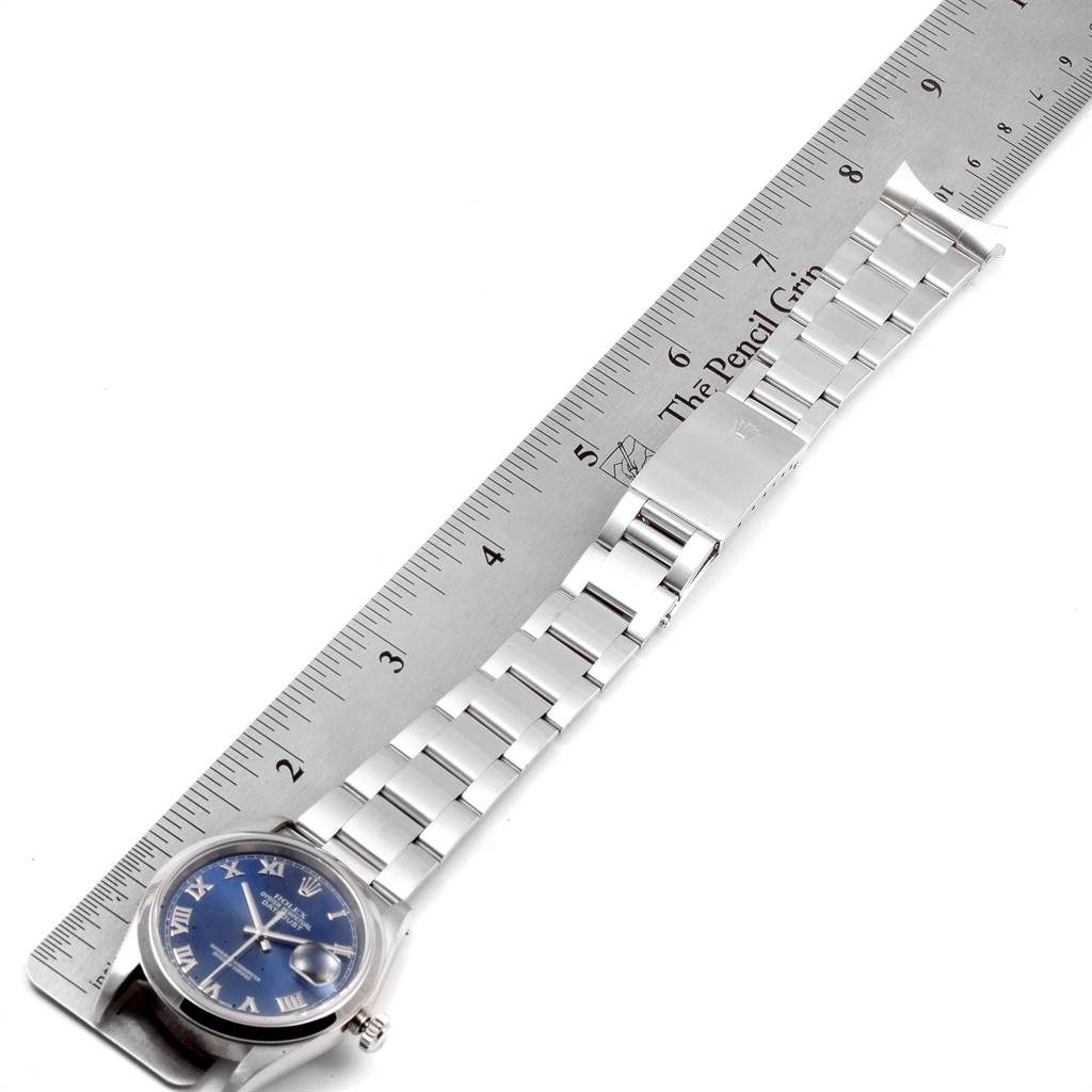 This image shows a Rolex Datejust 16200 Men's Stainless Steel Blue Dial 16200 Men's Stainless Steel Blue Dial watch laid flat, measured against a ruler, showing its bracelet and dial.