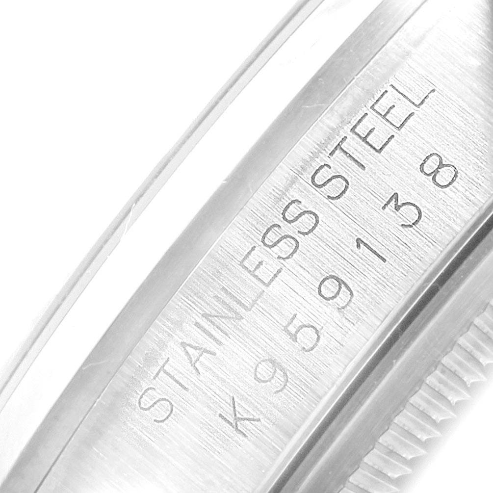 This image shows a close-up of the case side of a Rolex Datejust 16200 Men's Stainless Steel Blue Dial 16200 Men's Stainless Steel Blue Dial watch, featuring the serial number and "STAINLESS STEEL" engraving.