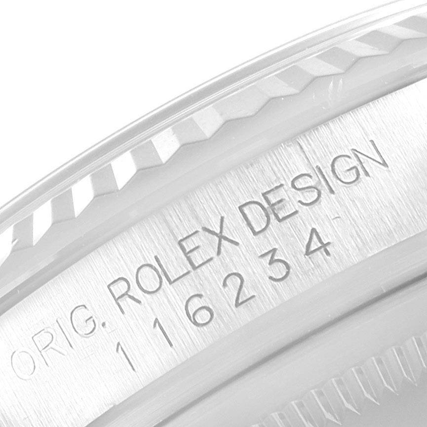 The image shows a close-up of the side engraving and fluted bezel of a Rolex Datejust 116234 Men's Stainless Steel Black Dial 116234 Men's Stainless Steel Black Dial model.