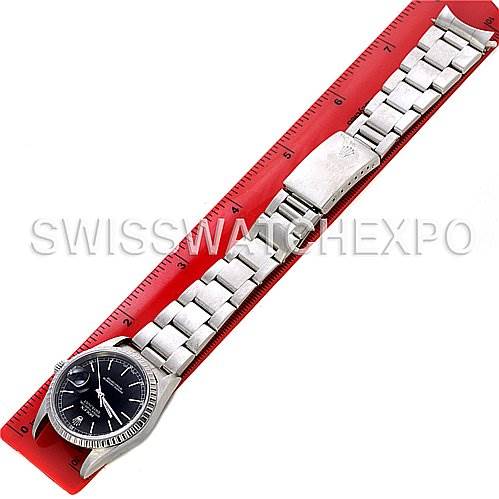 The image shows a full view of the Rolex Datejust 16200 Men's Stainless Steel Black Dial 16200 Men's Stainless Steel Black Dial watch, along with its metal bracelet and clasp, placed on a ruler for scale.