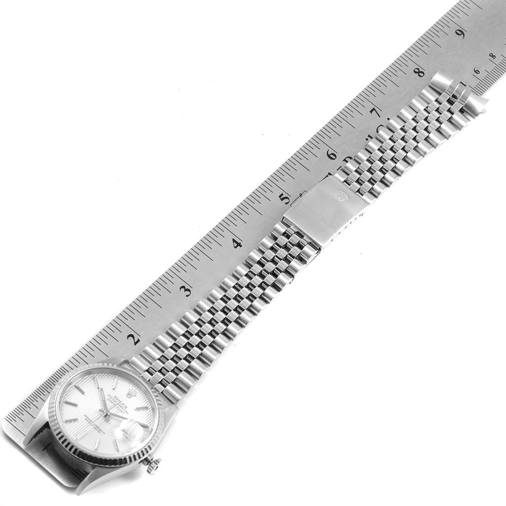 The image shows the Rolex Datejust 16234 Men's Stainless Steel Silver Dial 16234 Men's Stainless Steel Silver Dial watch laid flat next to a ruler, displaying the face and full length of the metal bracelet.