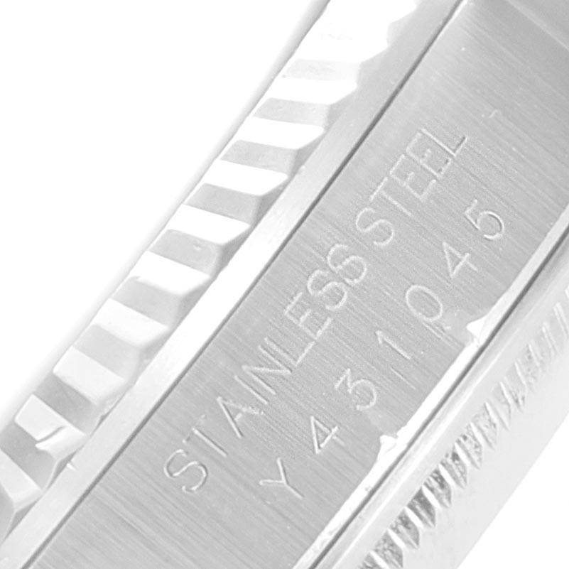 This image shows a close-up of the stainless steel bezel and some engravings on the side of the Rolex Datejust 16234 Men's Stainless Steel Silver Dial 16234 Men's Stainless Steel Silver Dial watch.
