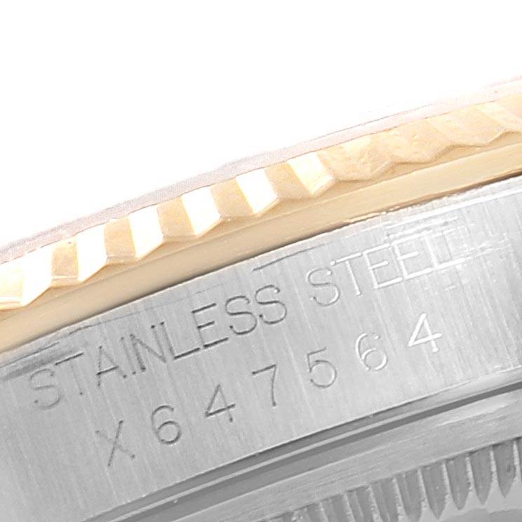 This image shows a close-up of the case edge and bezel of a Rolex Datejust 16233 Men's Steel and Gold (two tone) Champagne Dial 16233 Men's Steel and Gold (two tone) Champagne Dial watch, displaying the stainless steel text and serial number.