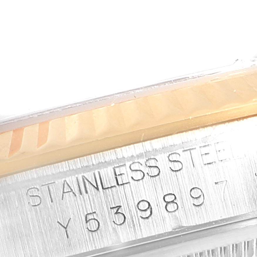 Close-up of the Rolex Datejust 16233 Men's Steel and Gold (two tone) Silver Dial 16233 Men's Steel and Gold (two tone) Silver Dial watch showing the fluted bezel and part of the stainless steel casing with serial number.