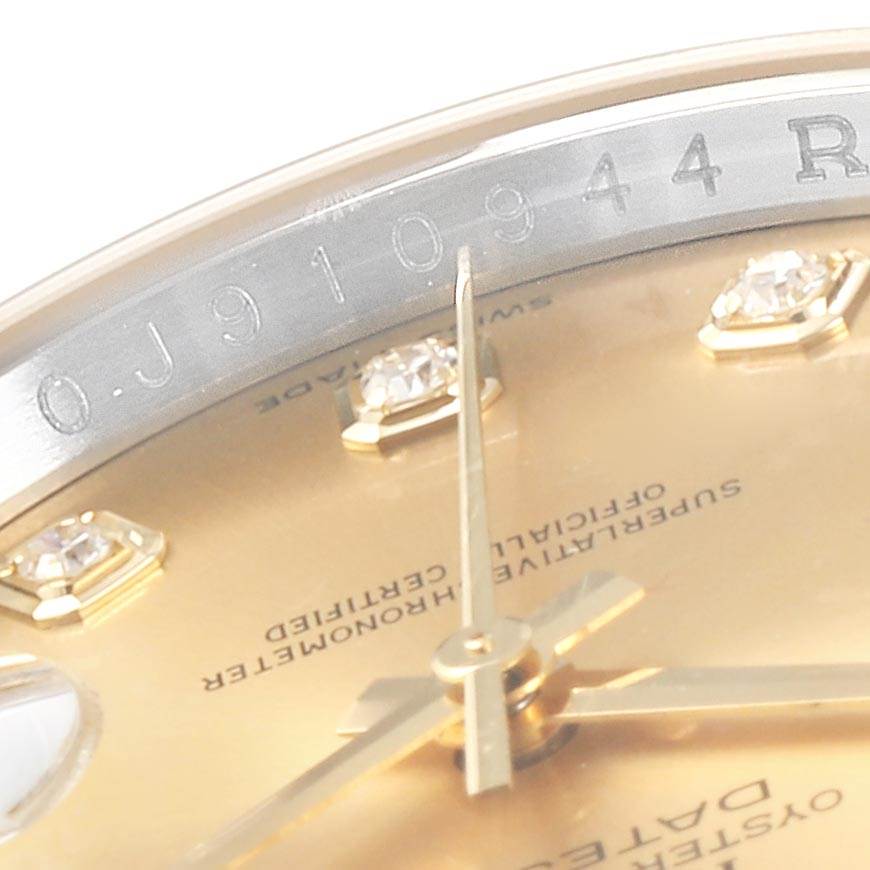 This close-up image of the Rolex Datejust 116243 Men
s Steel and Gold (two tone) Champagne Dial 116243 Men
s Steel and Gold (two tone) Champagne Dial watch shows the dial, hands, diamond hour markers, and part of the rehaut with engraved numbers.