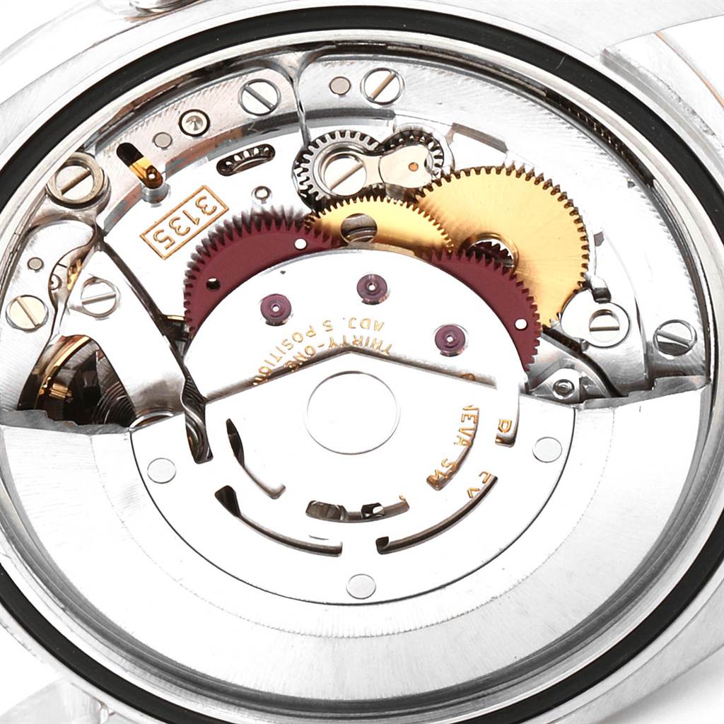 This is a close-up view of the movement mechanism inside a Rolex Datejust 116231 Men's Steel and Gold (two tone) Blue Dial 116231 Men's Steel and Gold (two tone) Blue Dial watch, showing gears and intricate components.