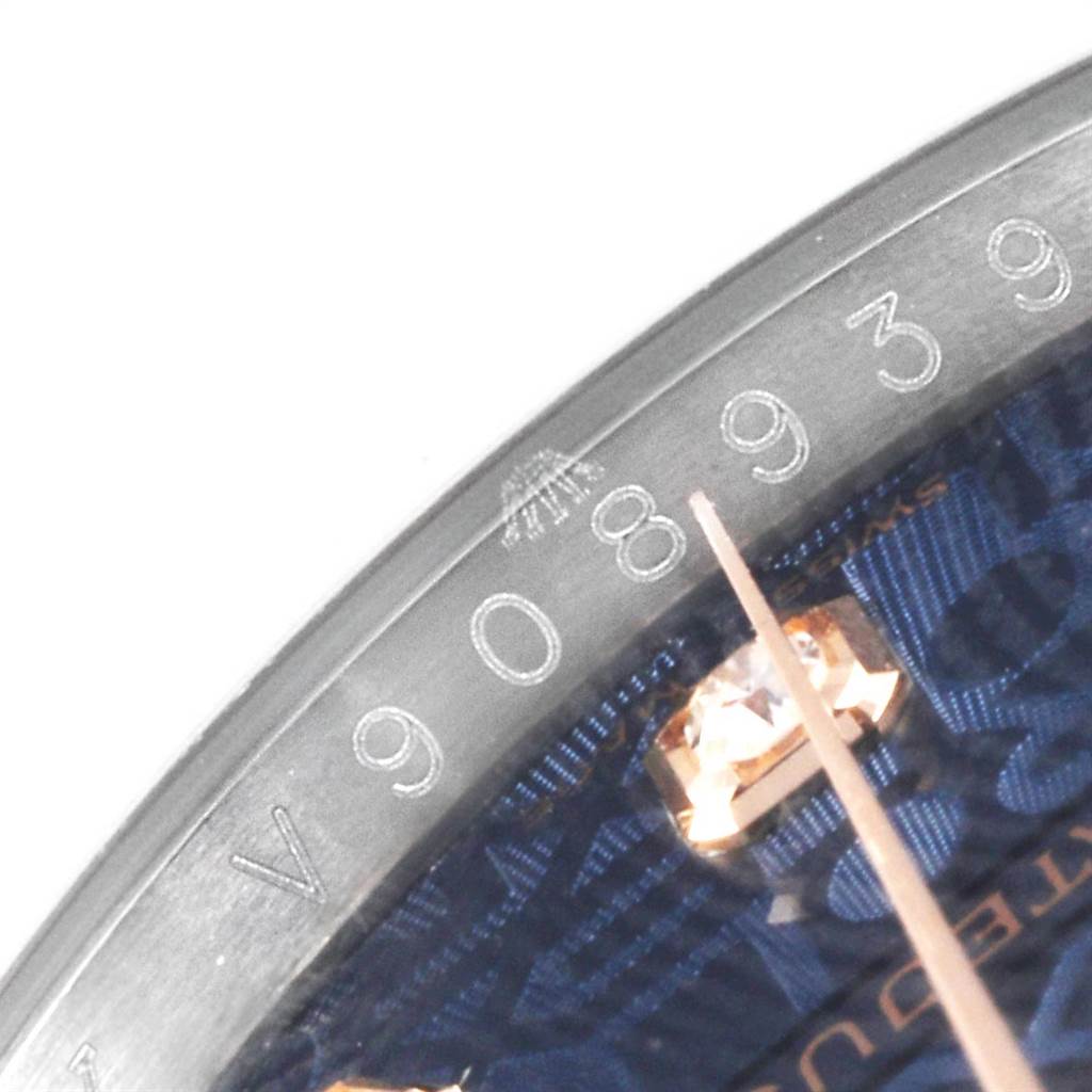 The image shows a close-up of the dial and edge of the bezel of a Rolex Datejust 116231 Men's Steel and Gold (two tone) Blue Dial 116231 Men's Steel and Gold (two tone) Blue Dial watch, featuring the numbers and a blue patterned design.