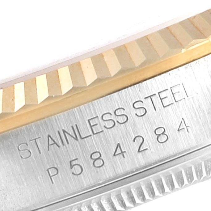 This image shows a close-up of the stainless steel case with a fluted bezel and serial number of a Rolex Datejust 16233 Men's Steel and Gold (two tone) Grey Dial 16233 Men's Steel and Gold (two tone) Grey Dial watch.