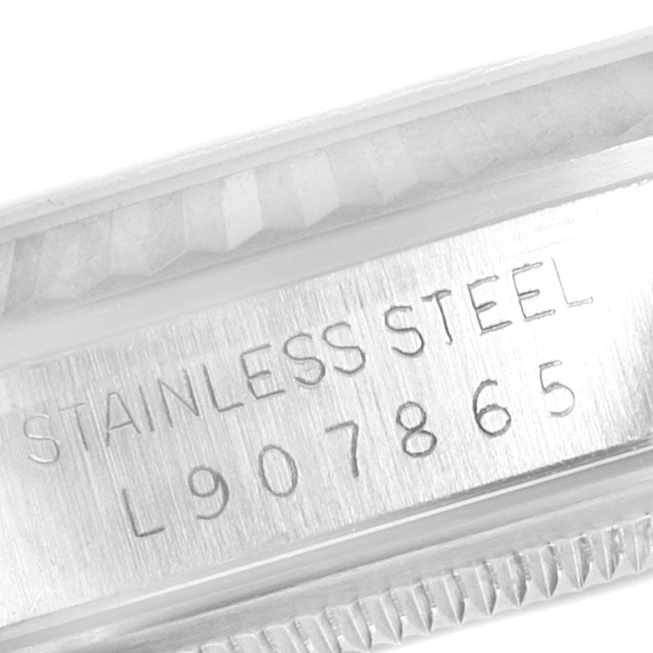 This close-up angle shows the serial number and stainless steel engraving on the side of the bezel of a Rolex Datejust 16234 Men's Stainless Steel Blue Dial 16234 Men's Stainless Steel Blue Dial watch.