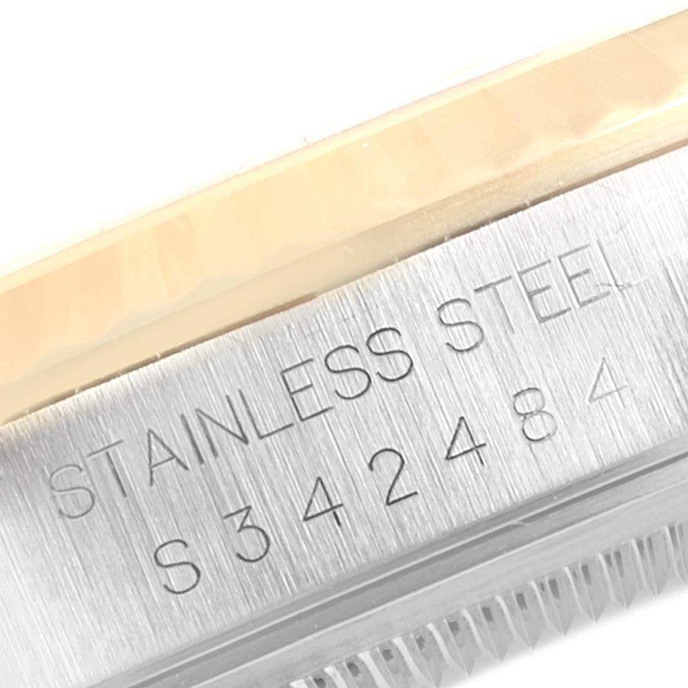 This image shows a close-up of the side of a Rolex Datejust 16233 Men's Steel and Gold (two tone) White Dial 16233 Men's Steel and Gold (two tone) White Dial model, highlighting the "Stainless Steel" engraving and serial number.