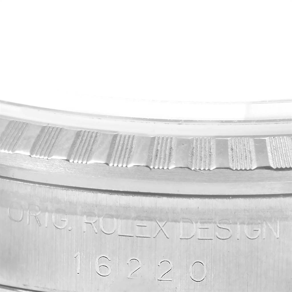 This close-up image shows the engraved serial number and fluted bezel of a Rolex Datejust 16220 Men's Stainless Steel Blue Dial 16220 Men's Stainless Steel Blue Dial model watch.
